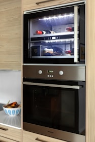 A kitchen with a built in oven and microwave