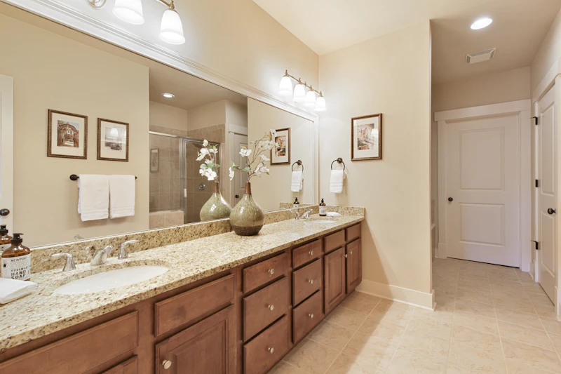 Renovated bathroom with double vanity and mirror