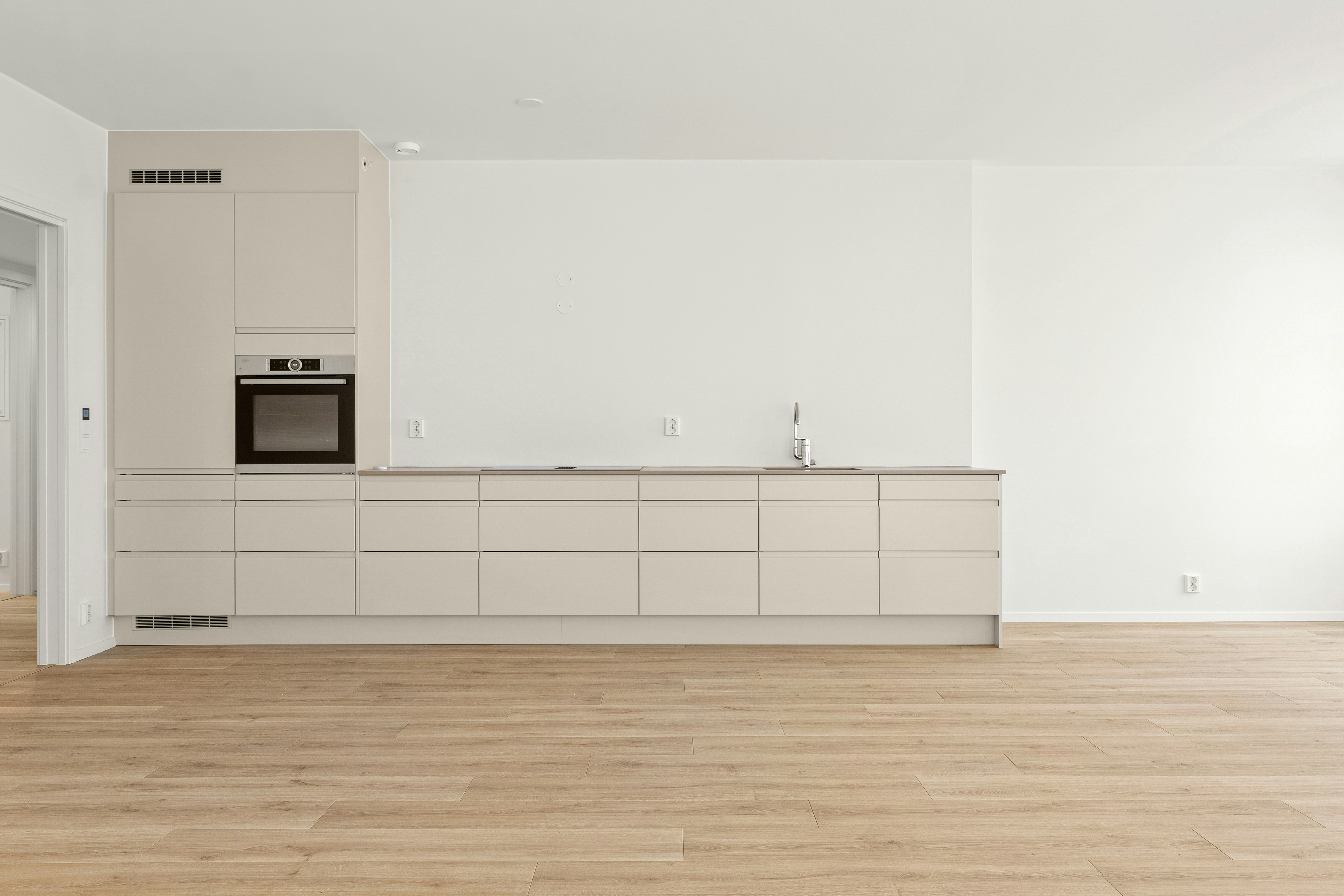 An empty kitchen and living room in an apartment