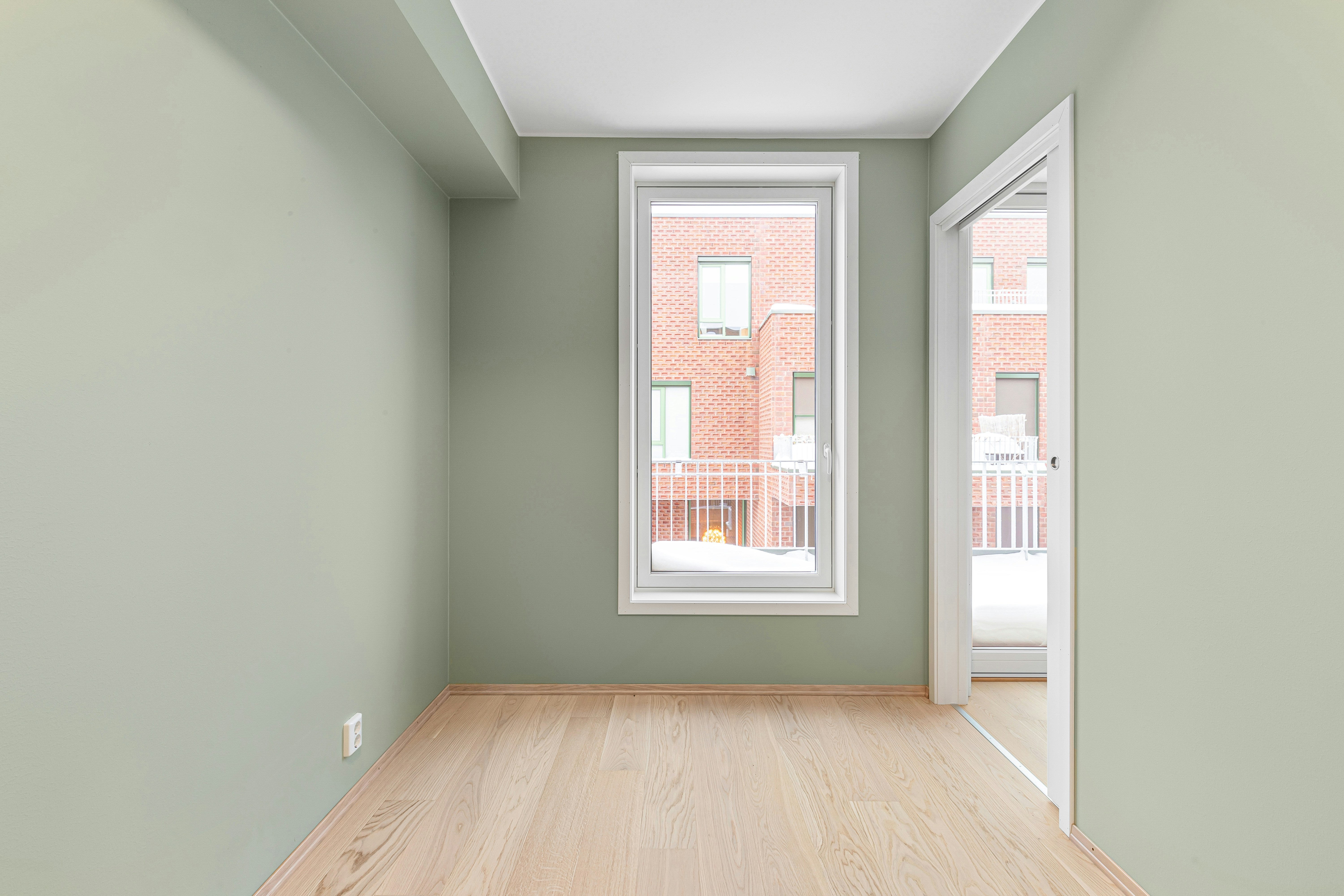 Empty room with sage green walls