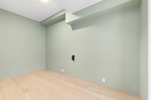 A empty room with a wooden floor and a ceiling fan