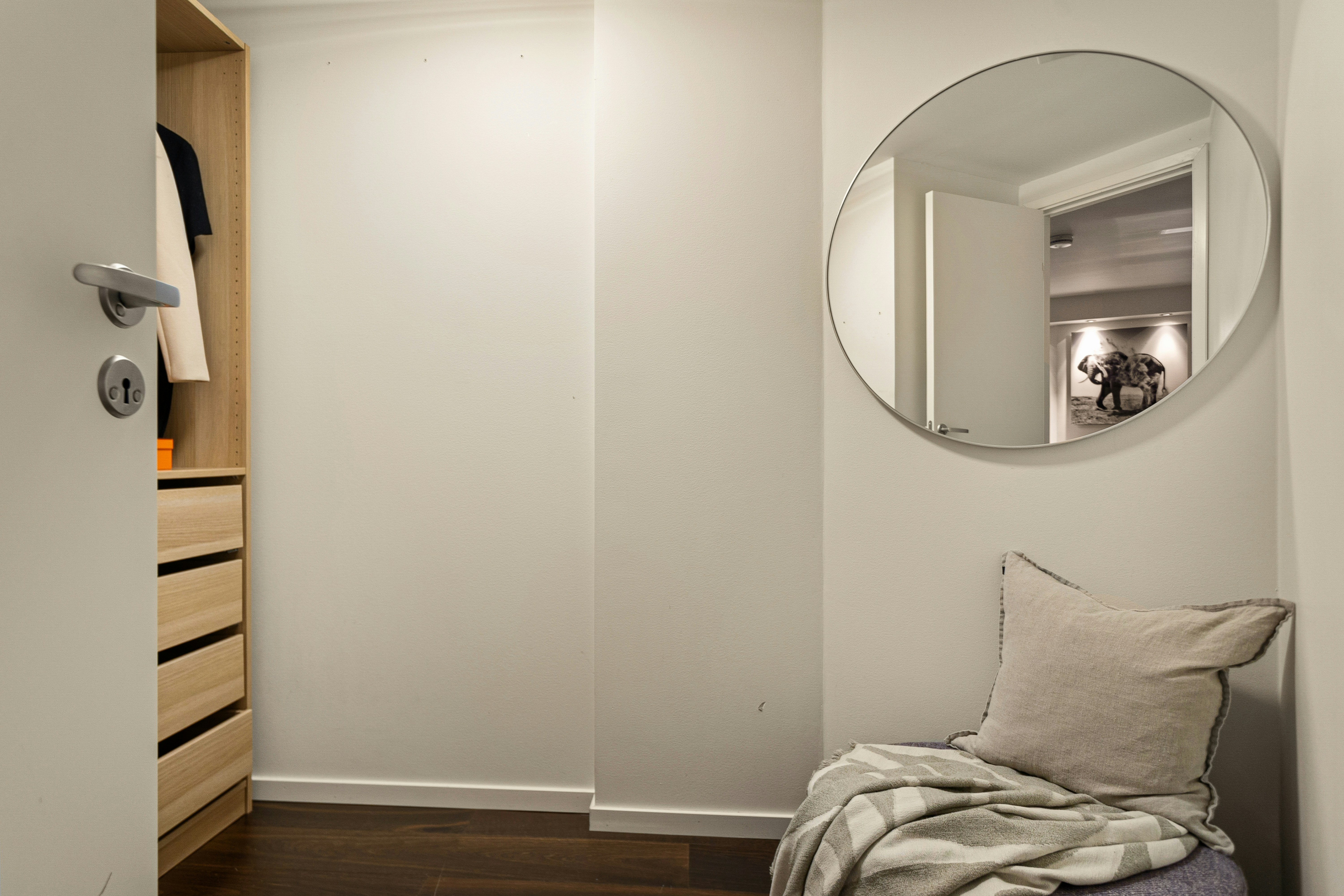 bright, airy apartment bedroom with tall mirrors reflecting a window - apartment ideas