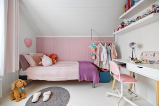 A child's bedroom with a bed, desk, and chair