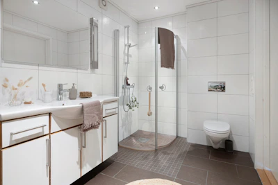 A bathroom with a toilet, sink, and shower