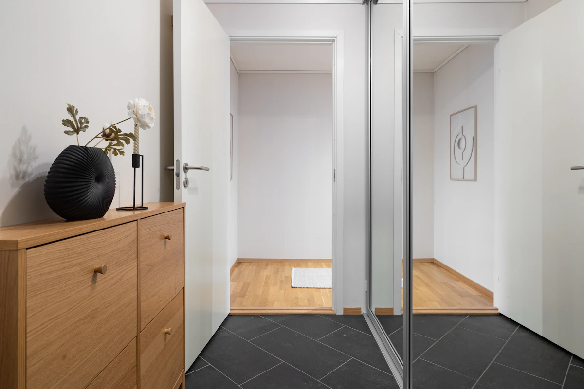 Renovated bathroom with frameless walk-in shower and floor tile