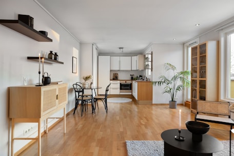 A living room filled with furniture and a wooden floor