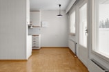 A room with a wooden floor and white walls