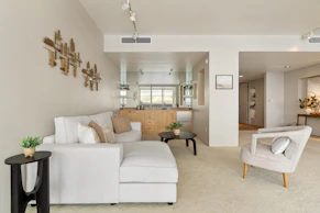 A living room filled with furniture and a white couch