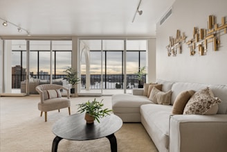 A living room filled with furniture and lots of windows