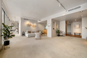 A large living room with a cream carpet 