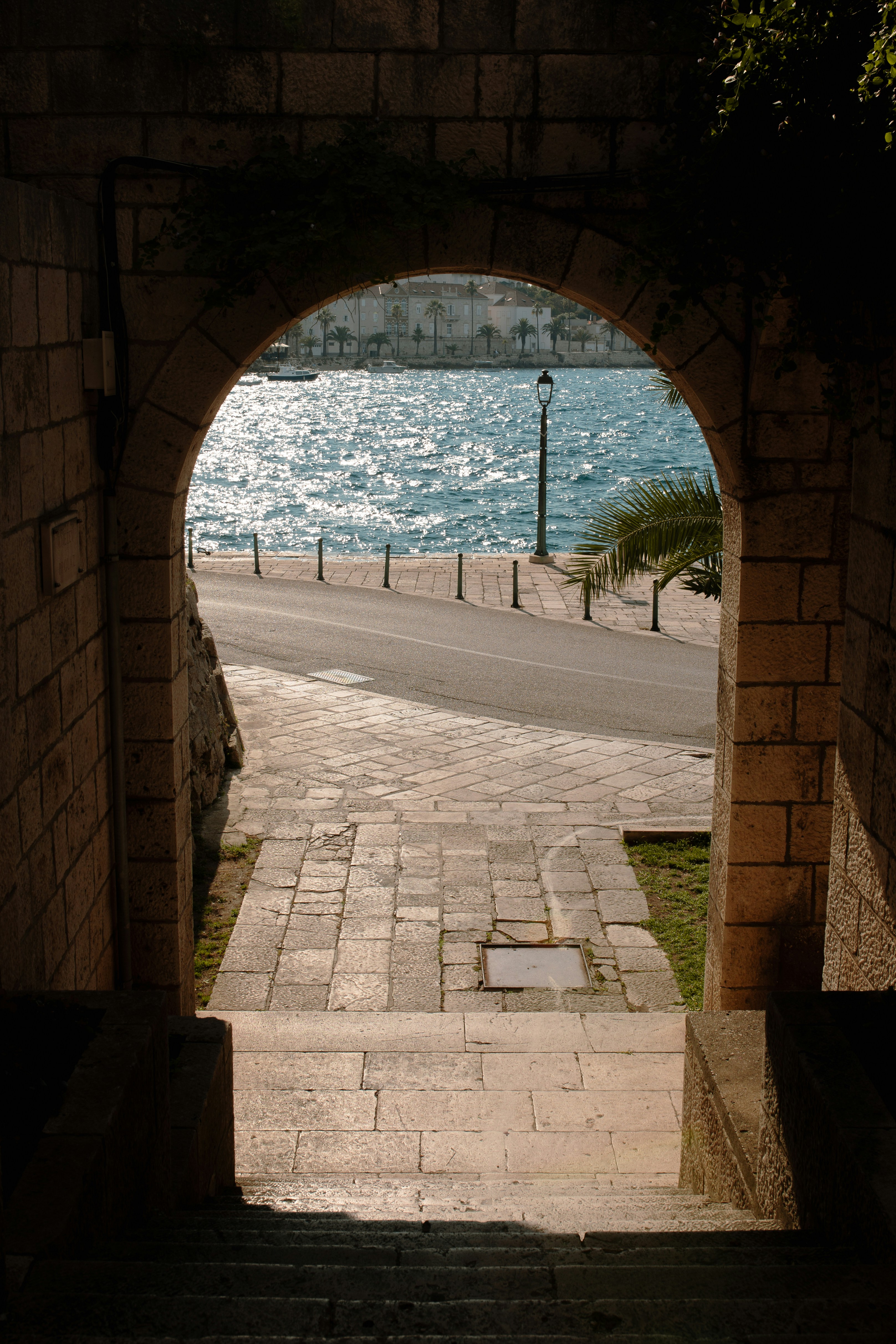 A view of the ocean through a stone archway