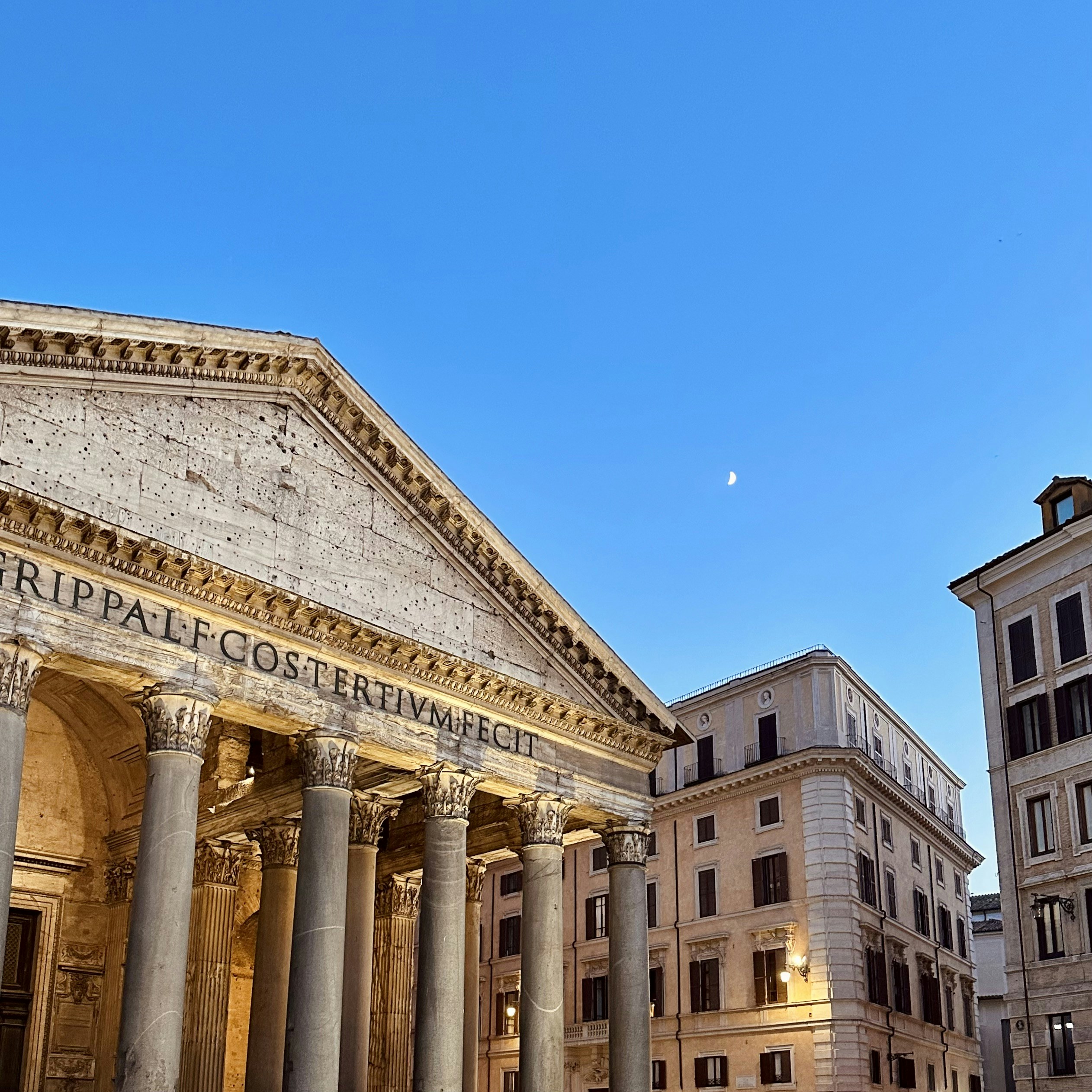 A large building with columns and a clock tower