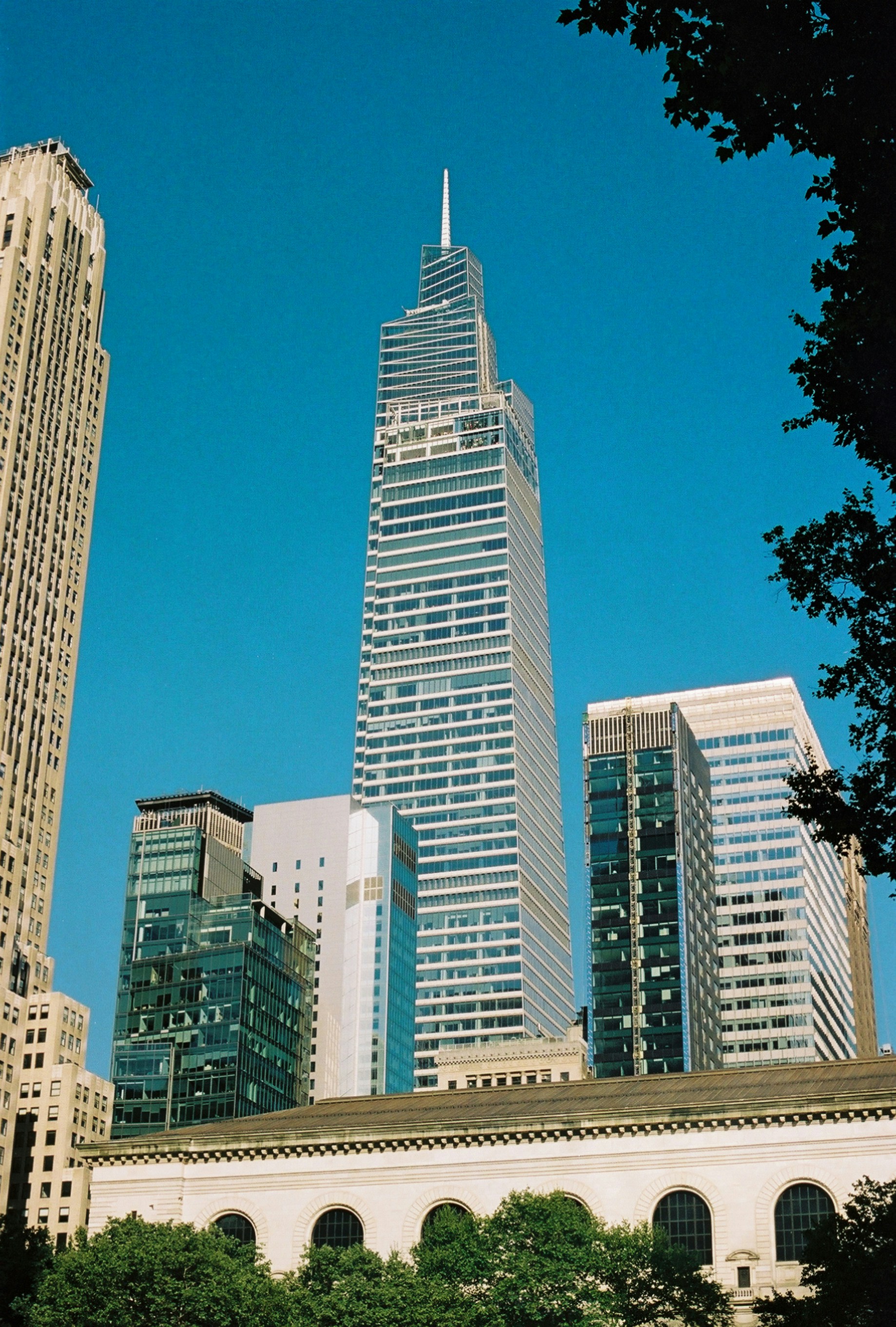 A tall building towering over a city filled with tall buildings