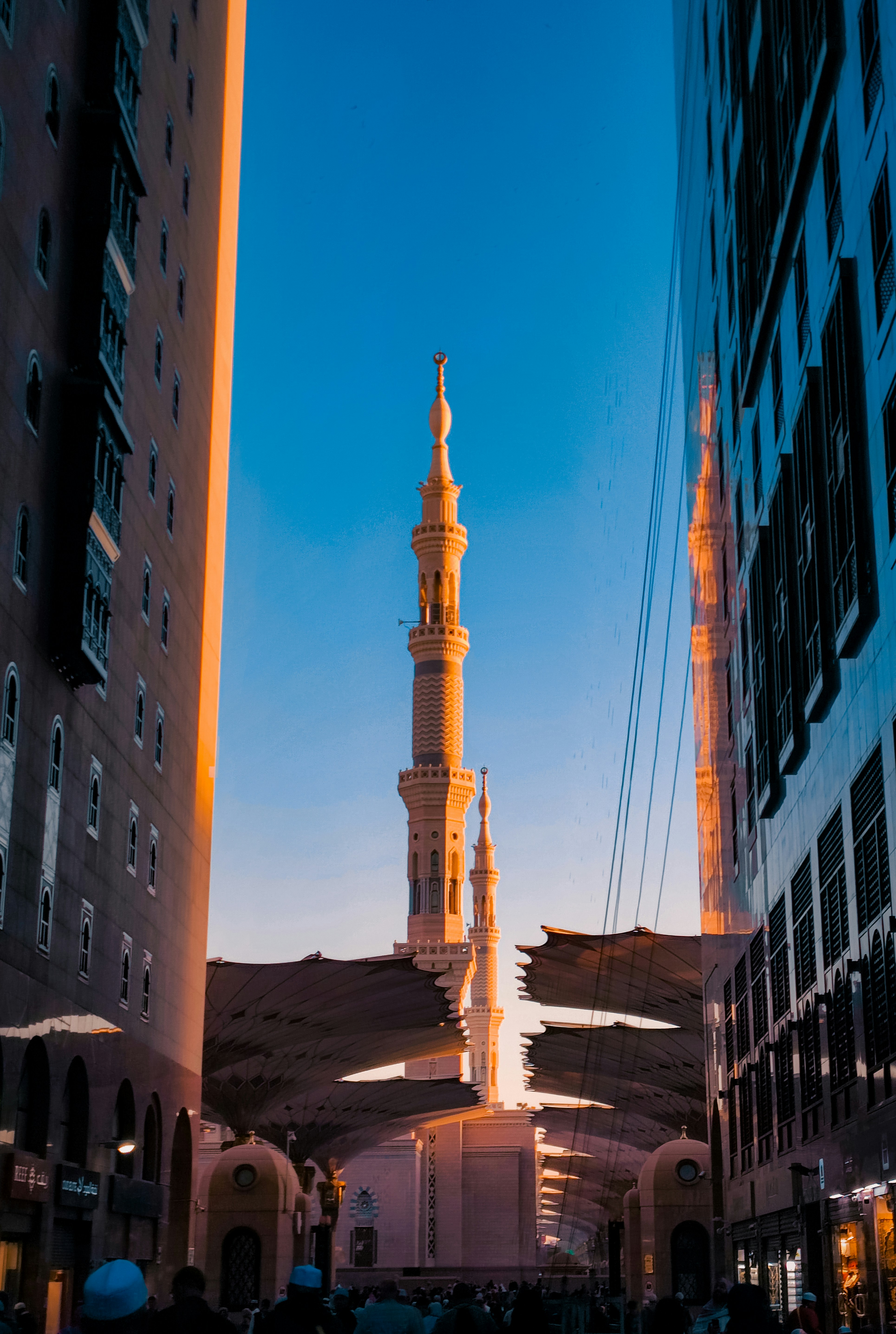 A tall white building with a clock tower in the middle of it