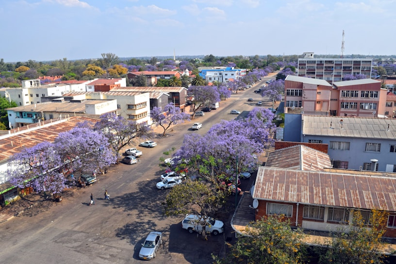 A view of a street with cars parked in front of buildings