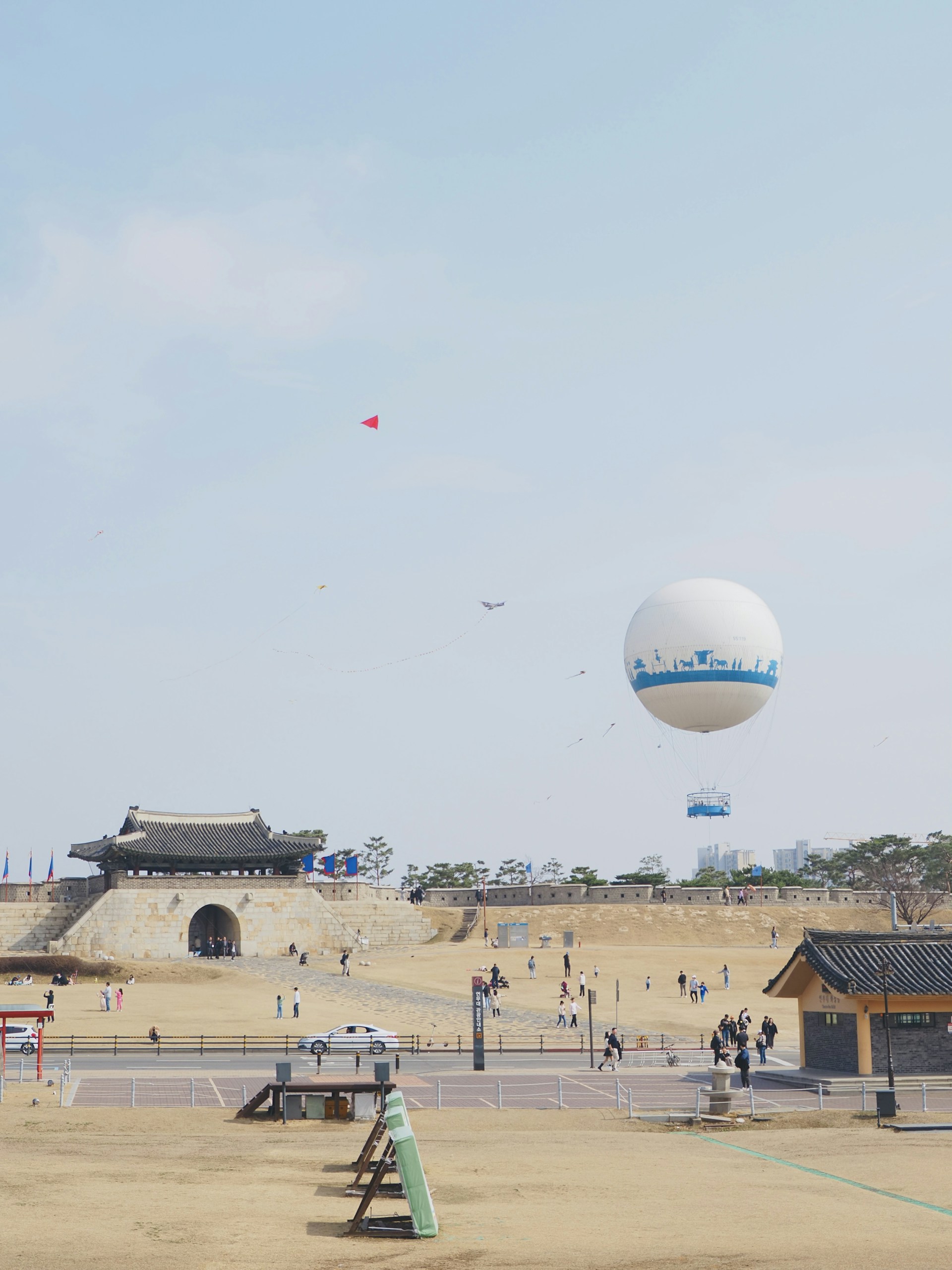 A group of people flying kites over a sandy beach