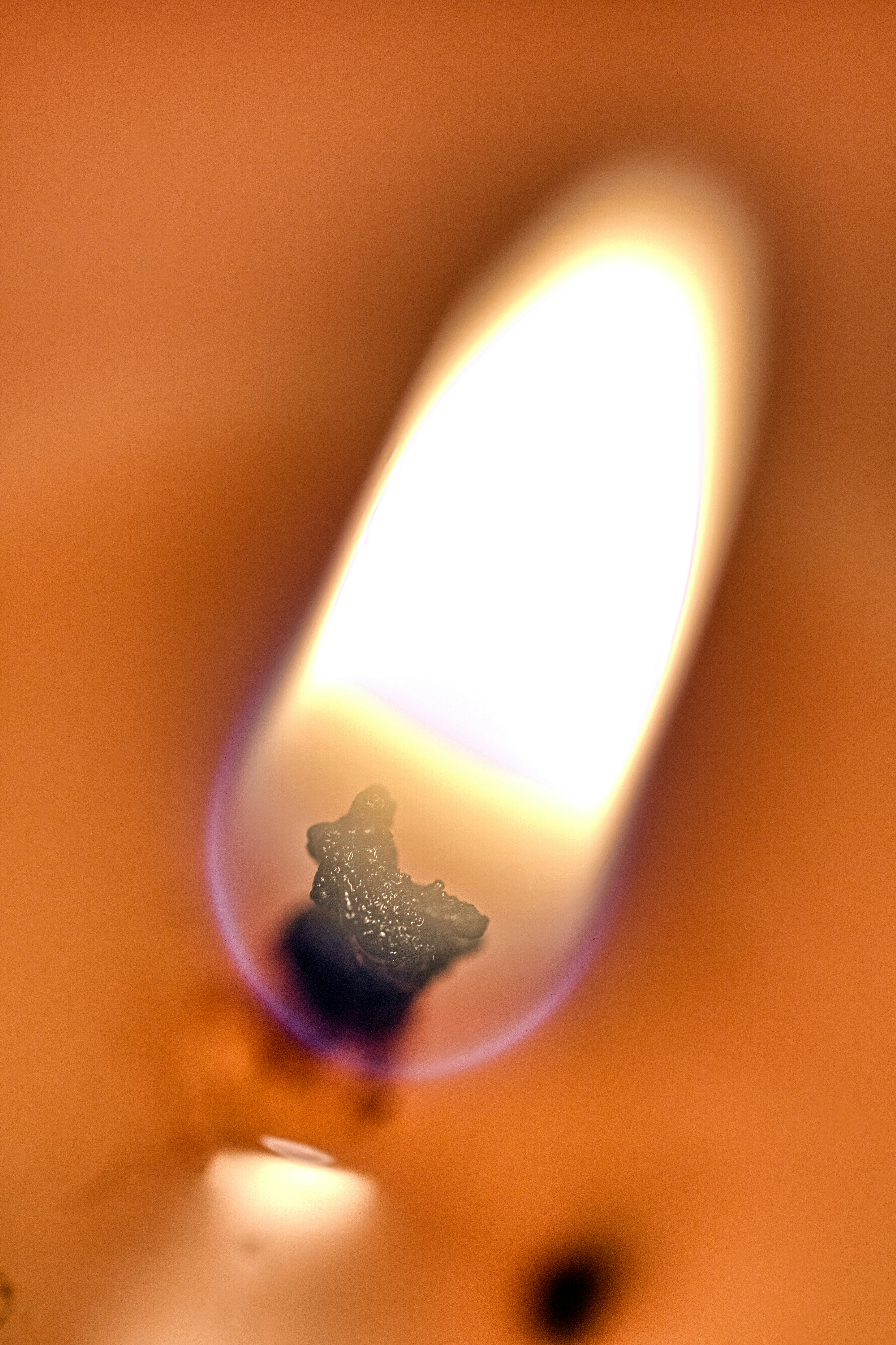 A candle safely burning on a heat-resistant surface