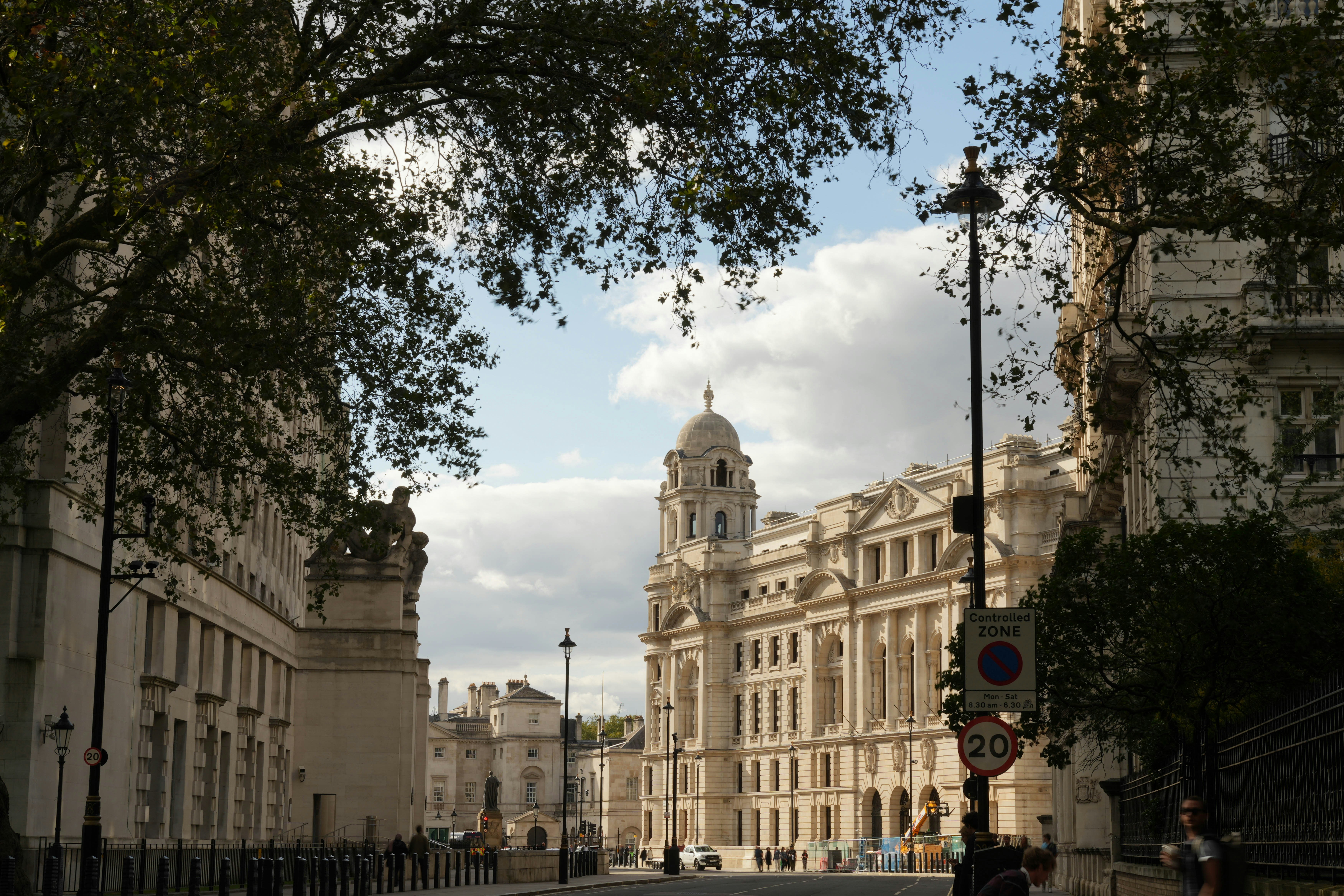 A city street with a clock tower in the background