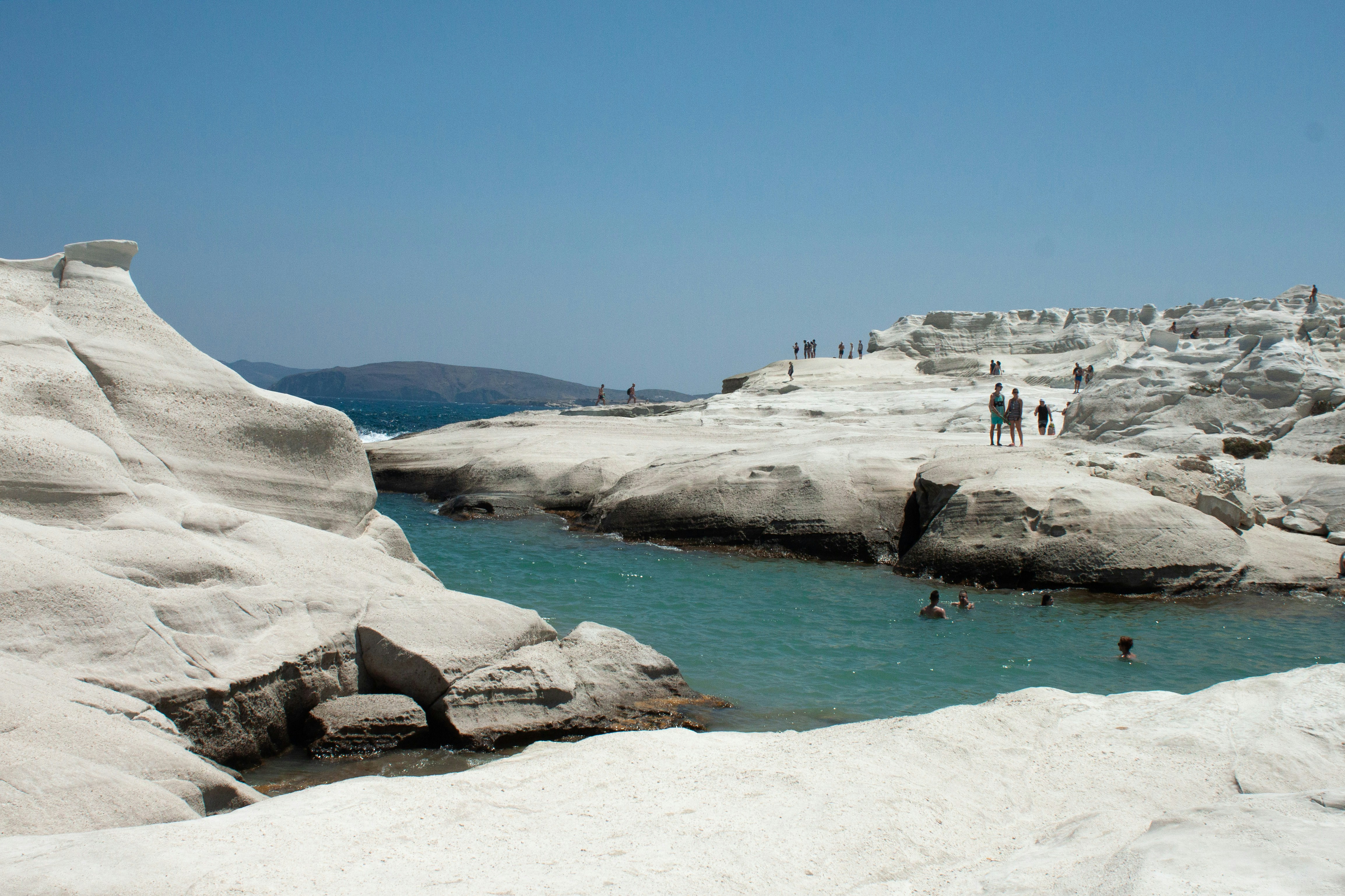 A body of water surrounded by snow covered rocks