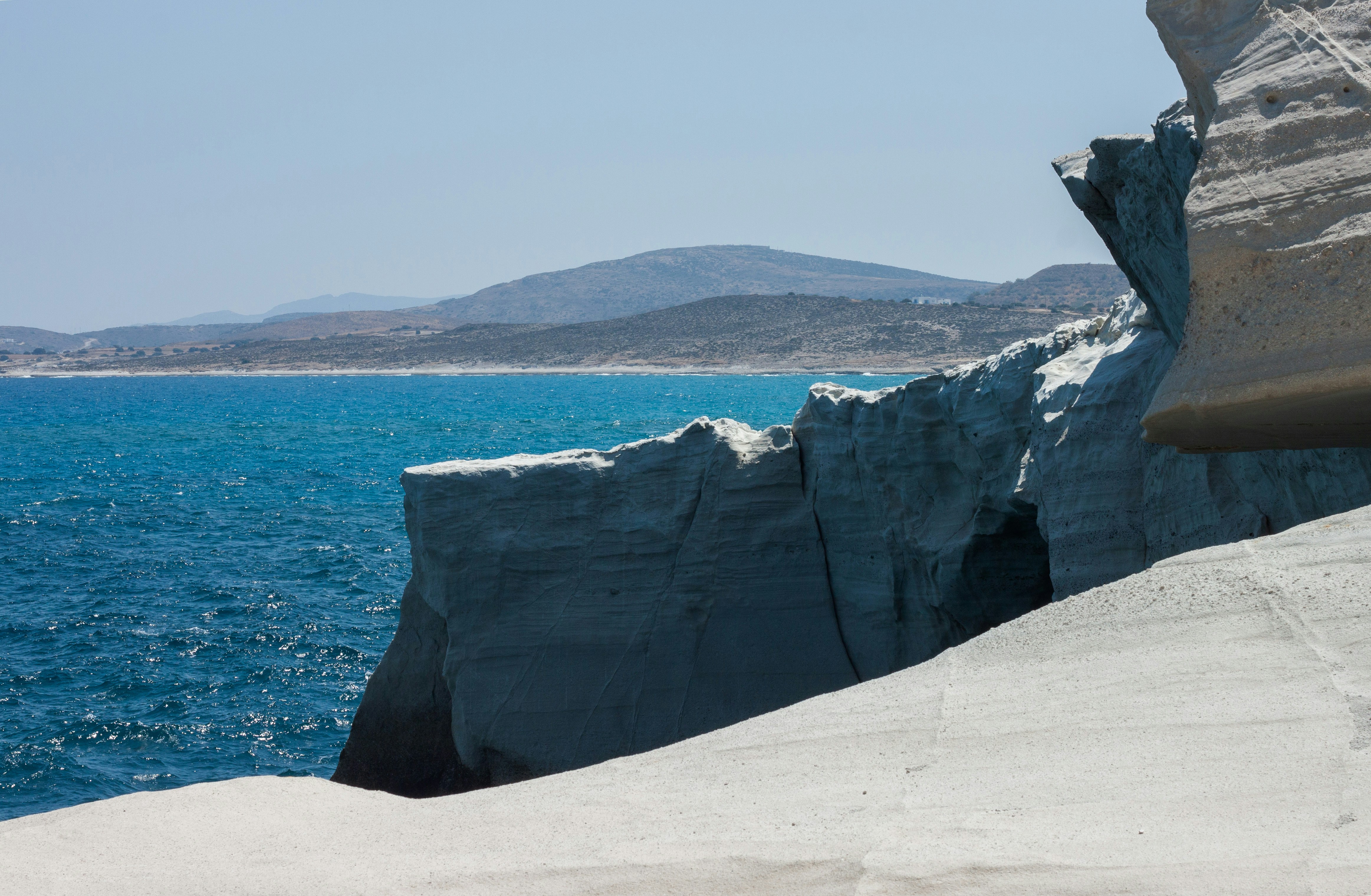 A man riding a snowboard down a snow covered slope