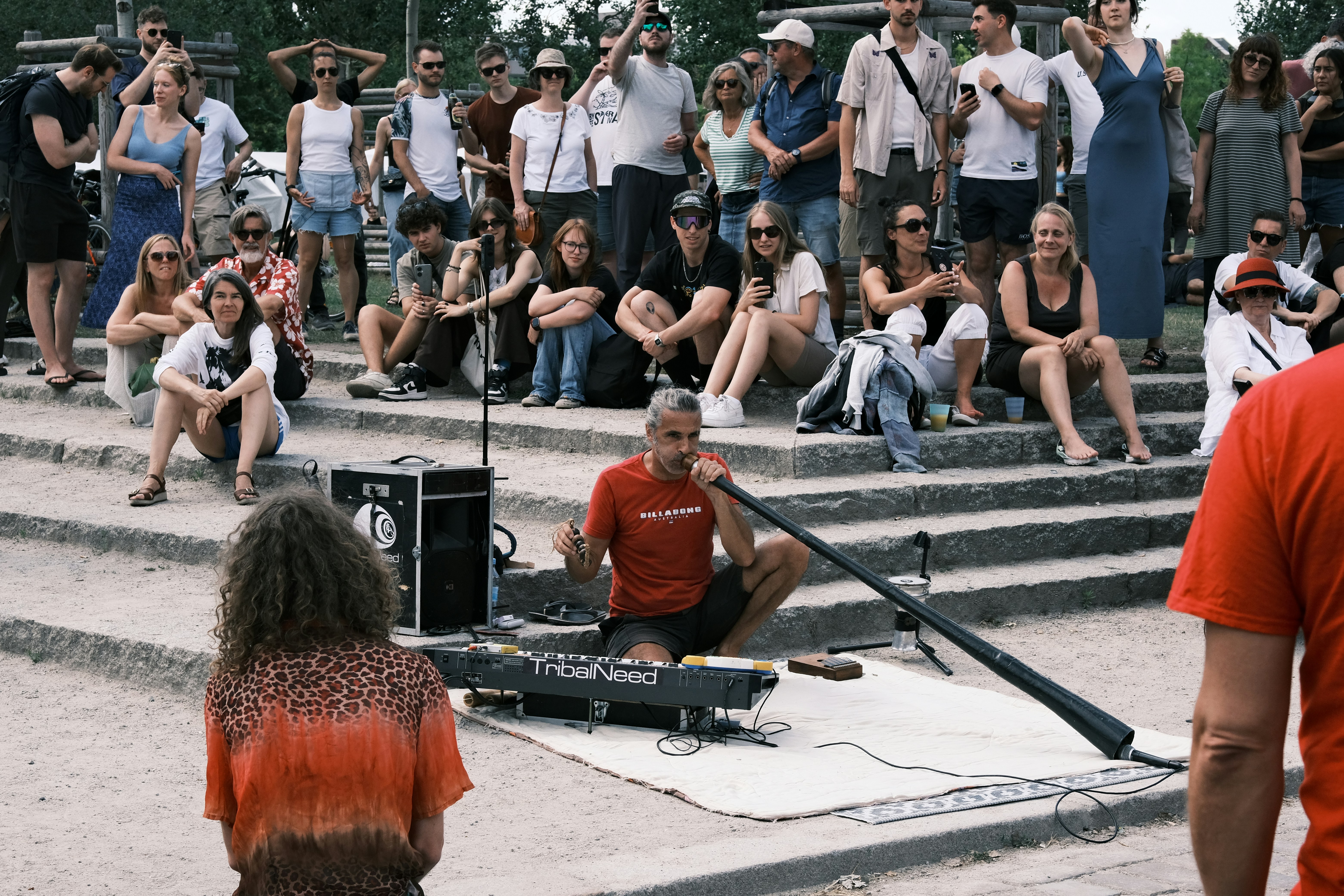 A group of people sitting and standing around a stage