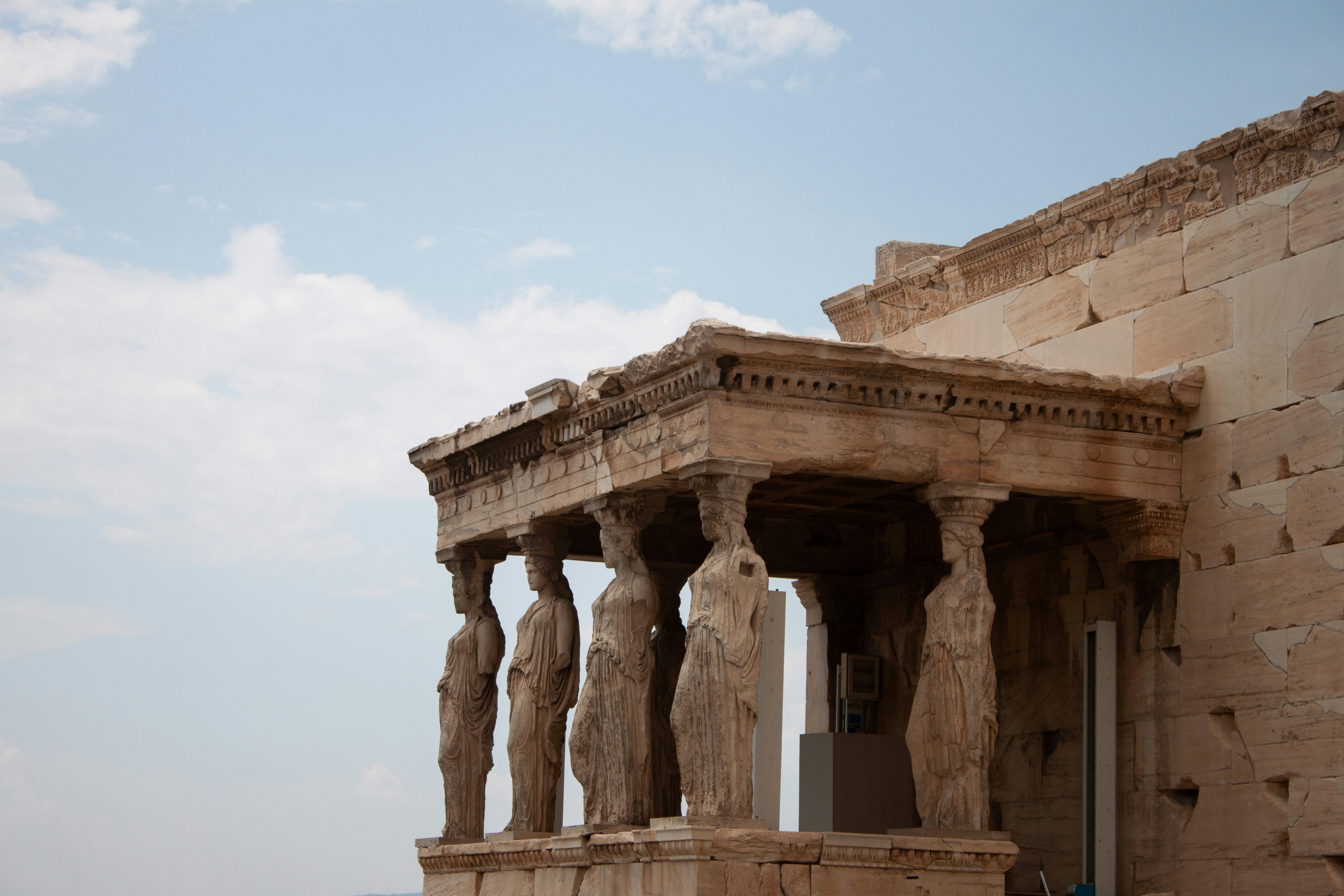 A large building with statues on the side of it