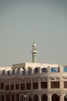 A large building with a clock tower in the background