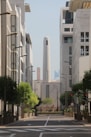 A city street with tall buildings in the background