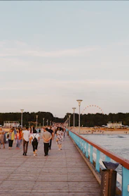 A group of people walking across a bridge