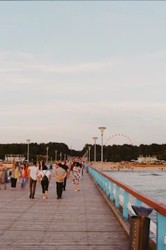A group of people walking across a bridge