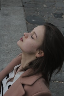 A woman sitting on the ground with her eyes closed