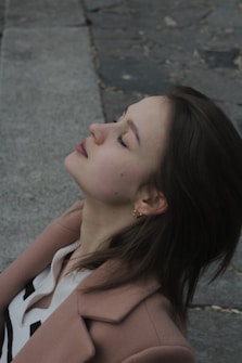 A woman sitting on the ground with her eyes closed