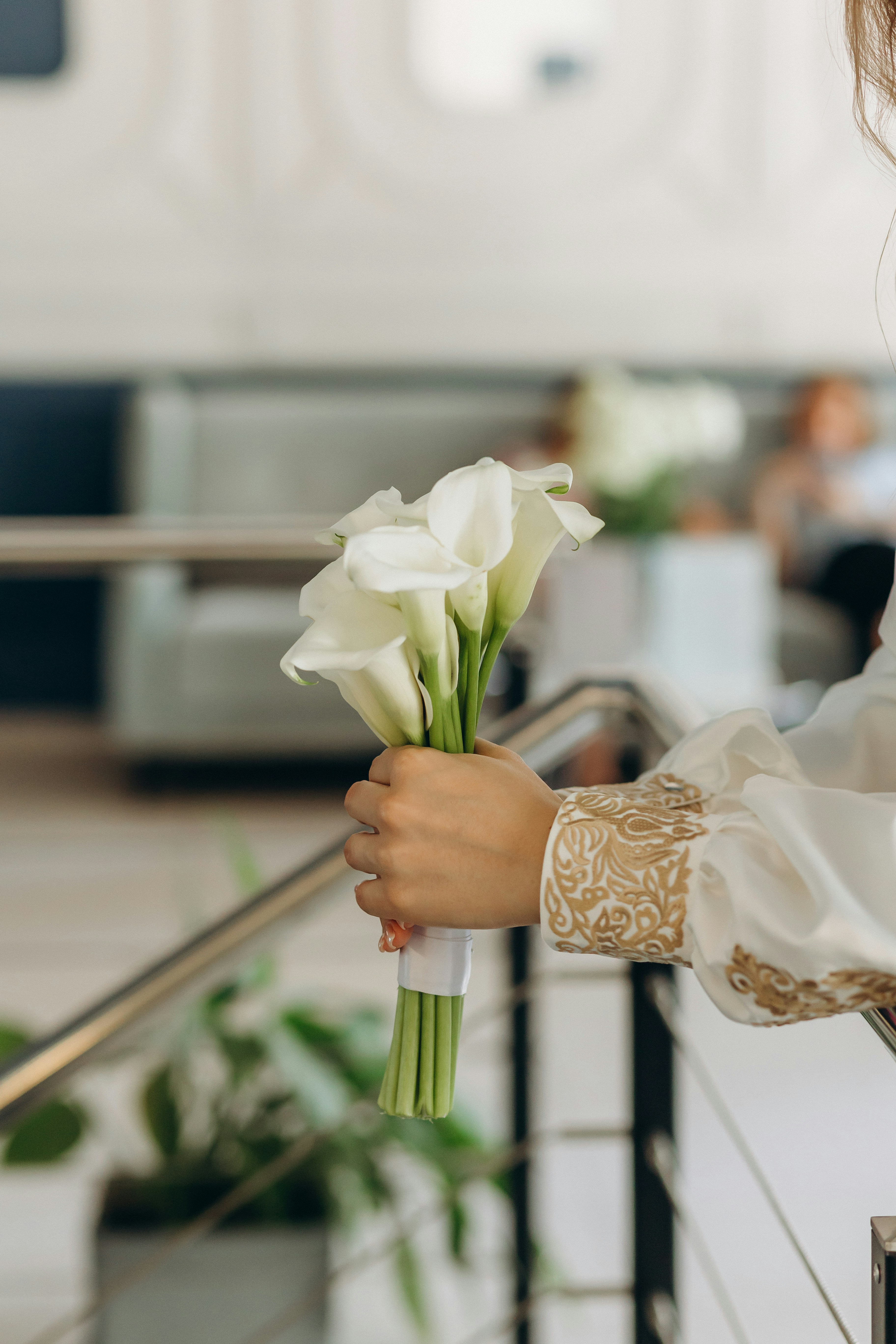 A woman holding a bouquet of white flowers