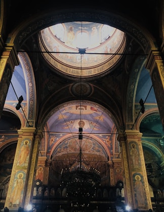 A church with a large ceiling and a stained glass window