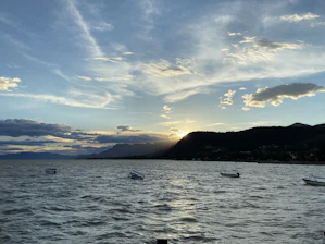 A group of boats floating on top of a large body of water