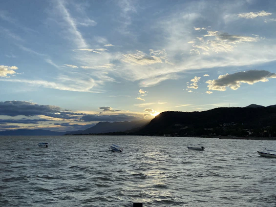 A group of boats floating on top of a large body of water
