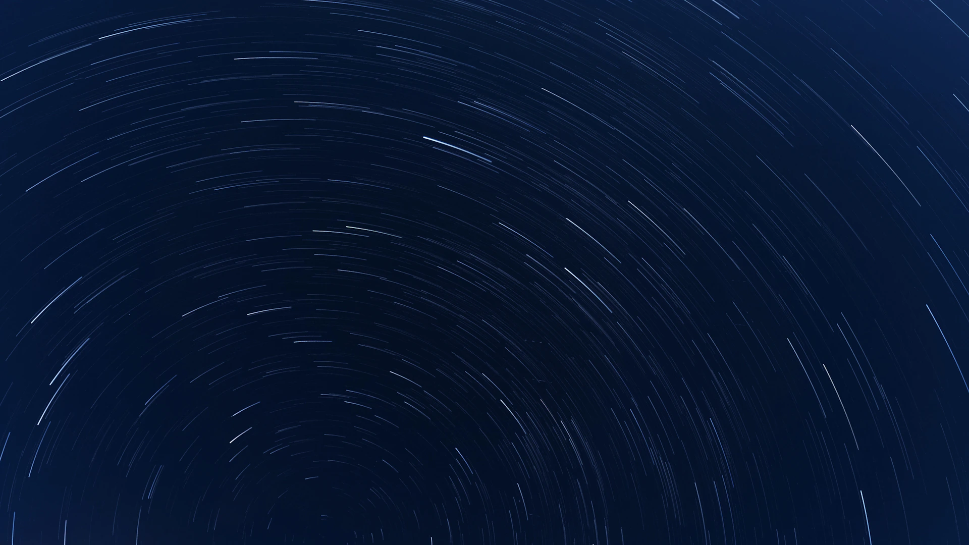 A star trail is shown in the night sky