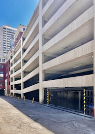 An empty parking garage in front of a tall building