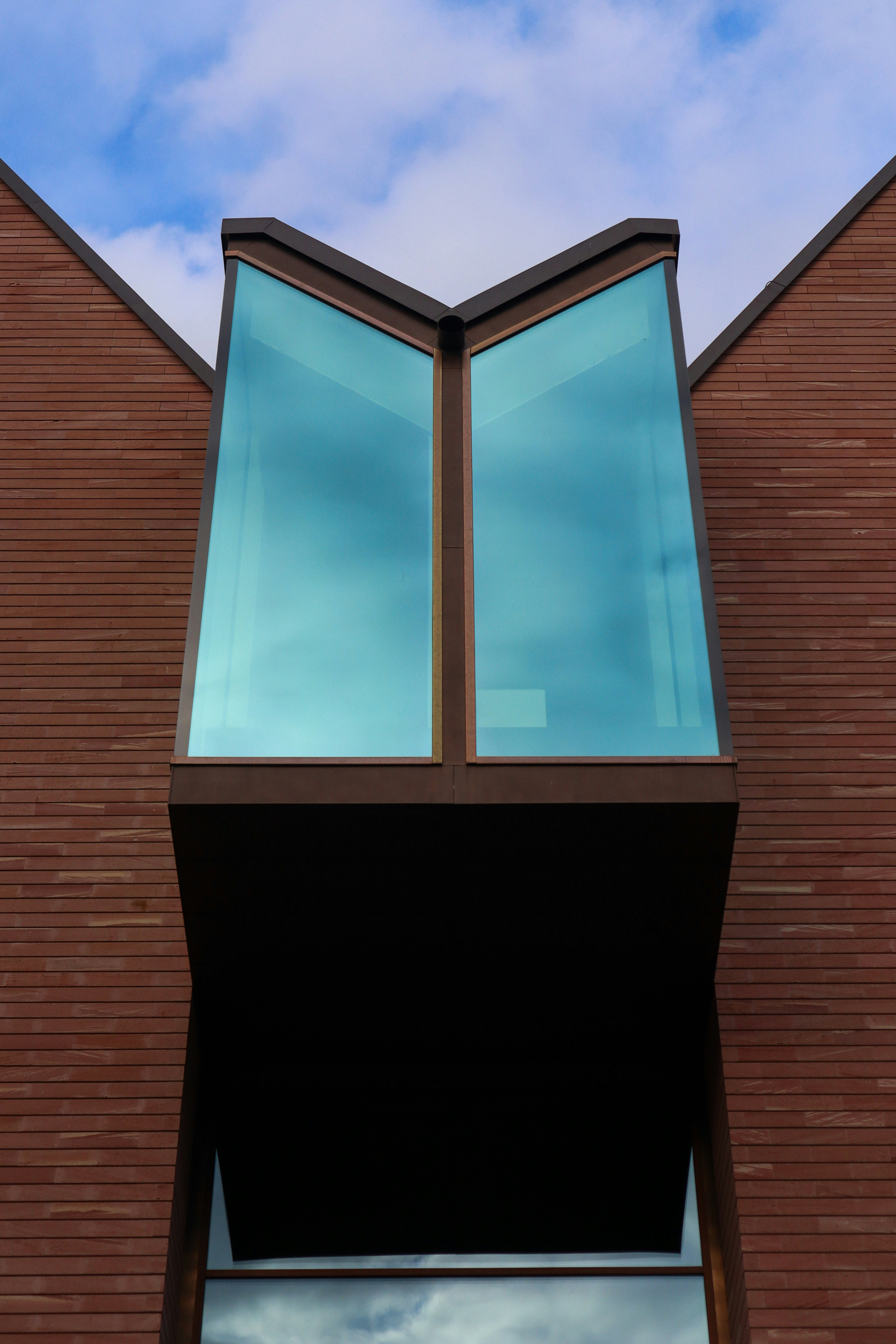 A brick building with two windows and a sky background photo – Free ...