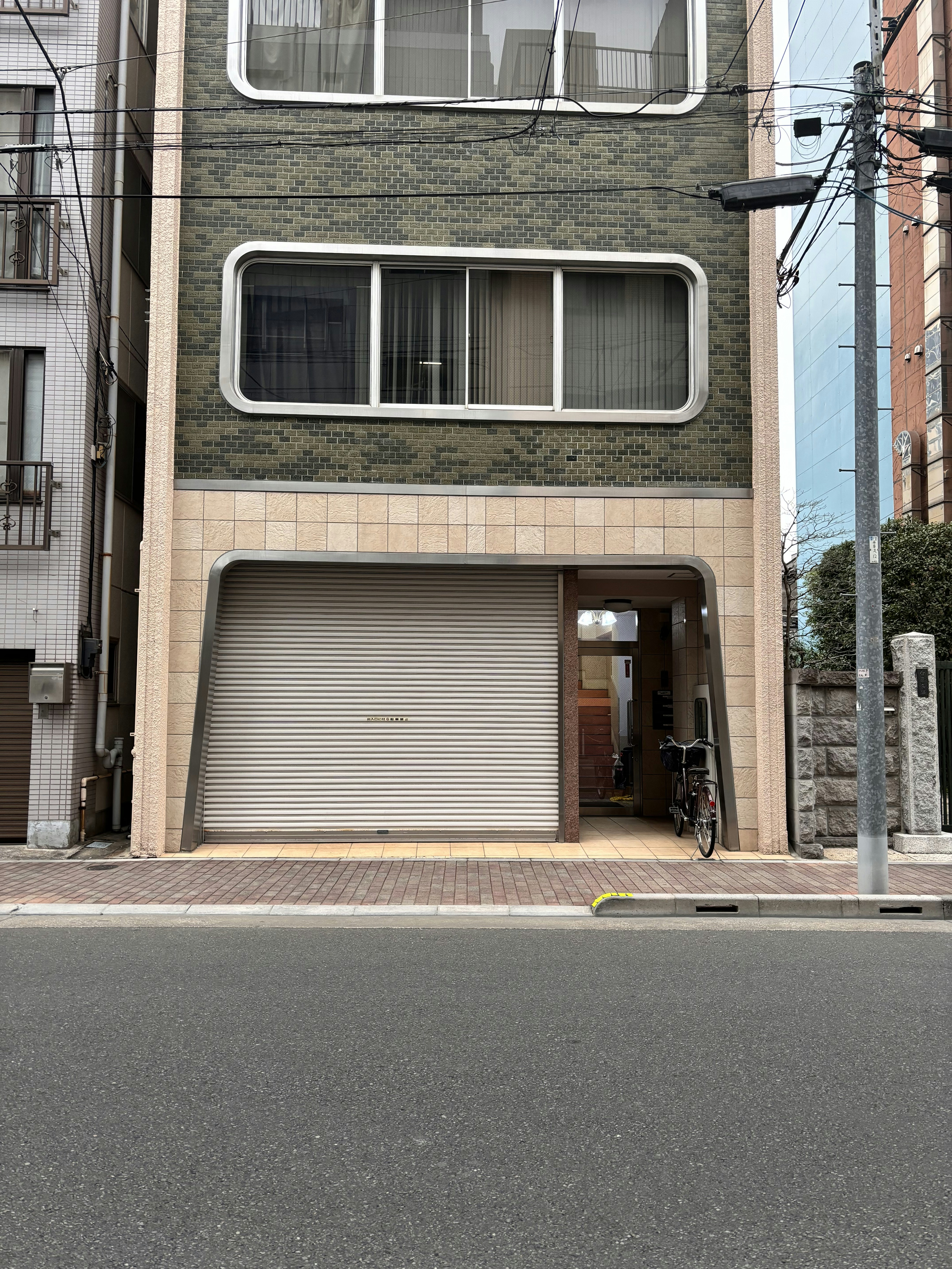 A tall building with a garage in front of it
