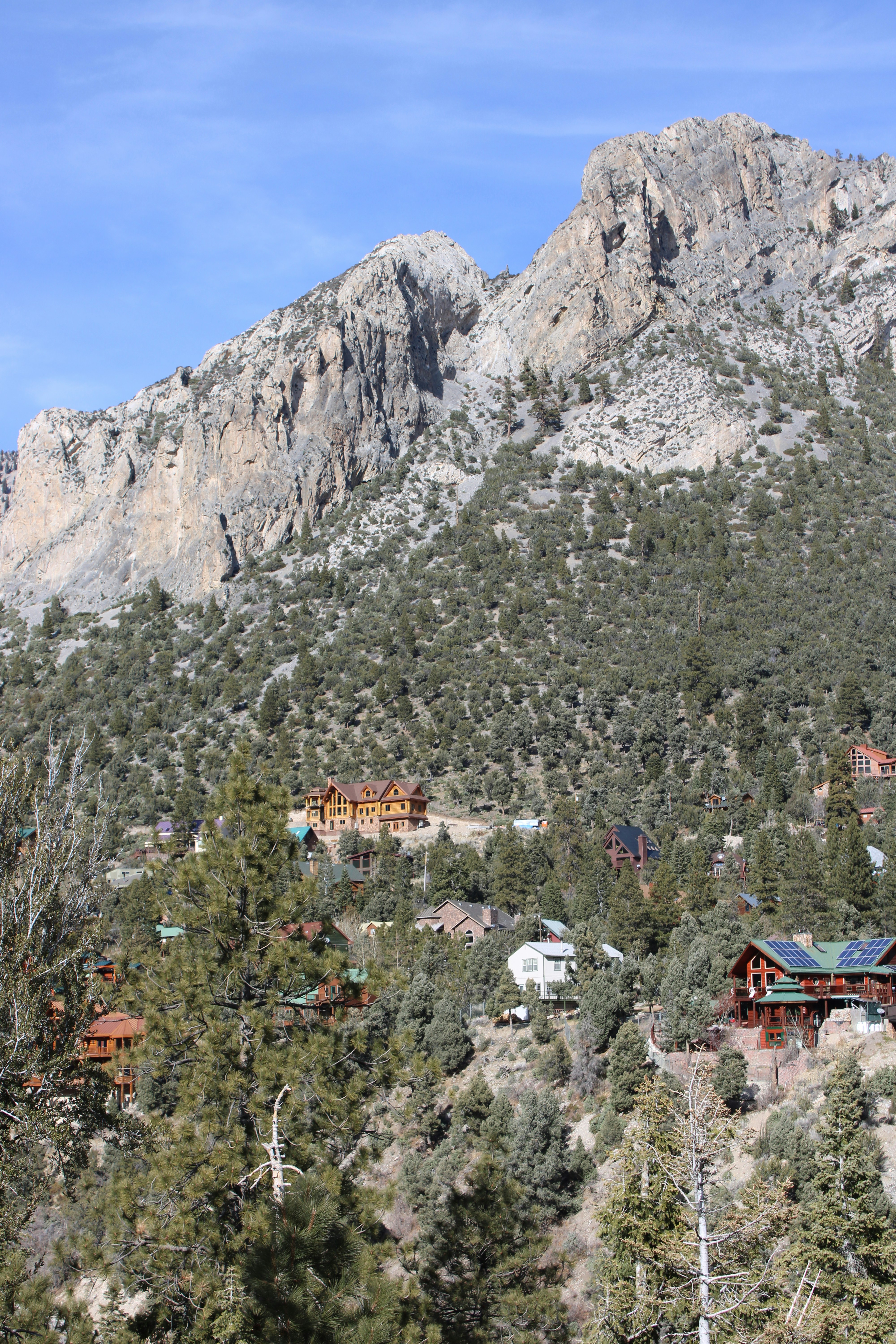 A view of a mountain with a lodge in the foreground