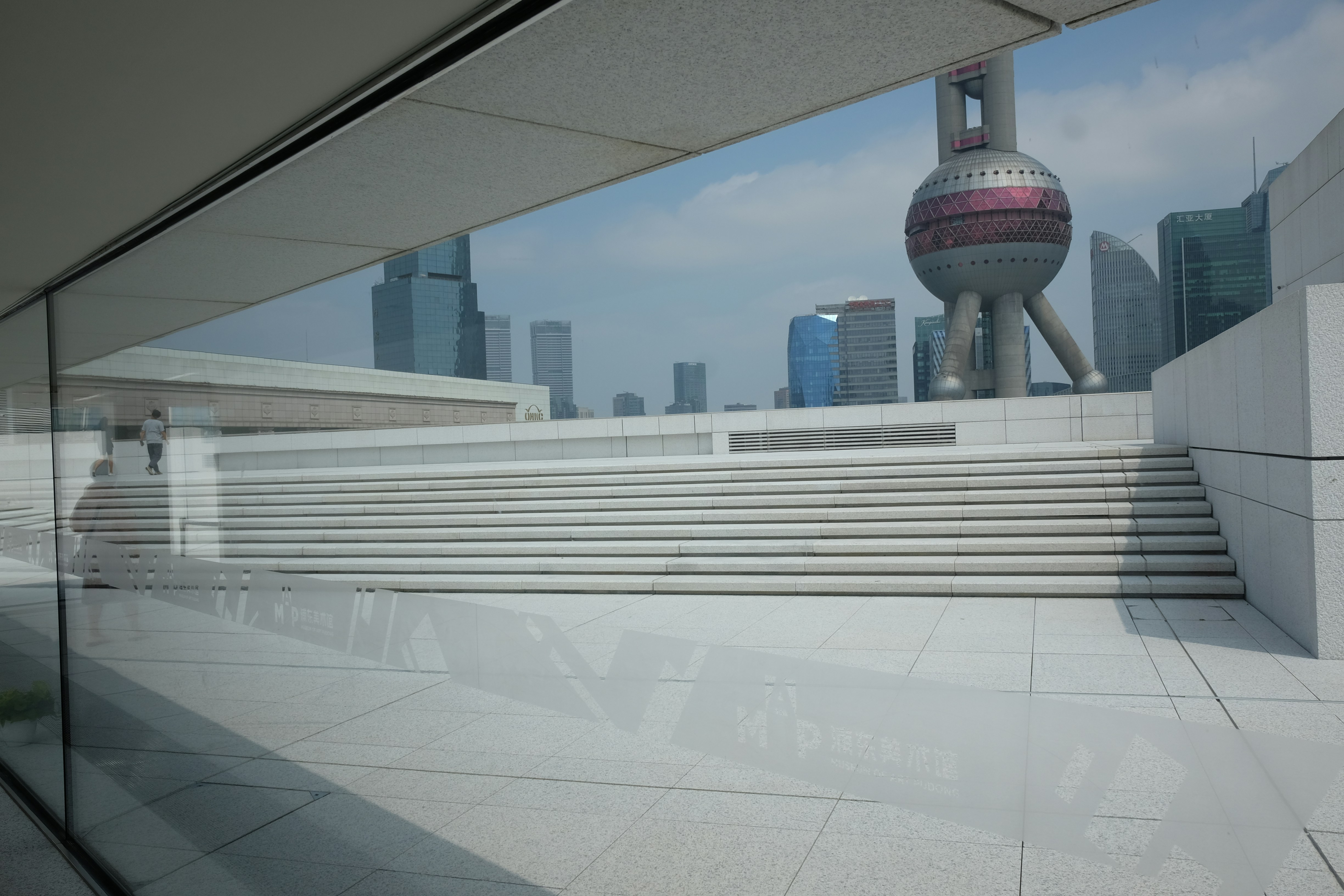 A large building with a very tall tower in the background