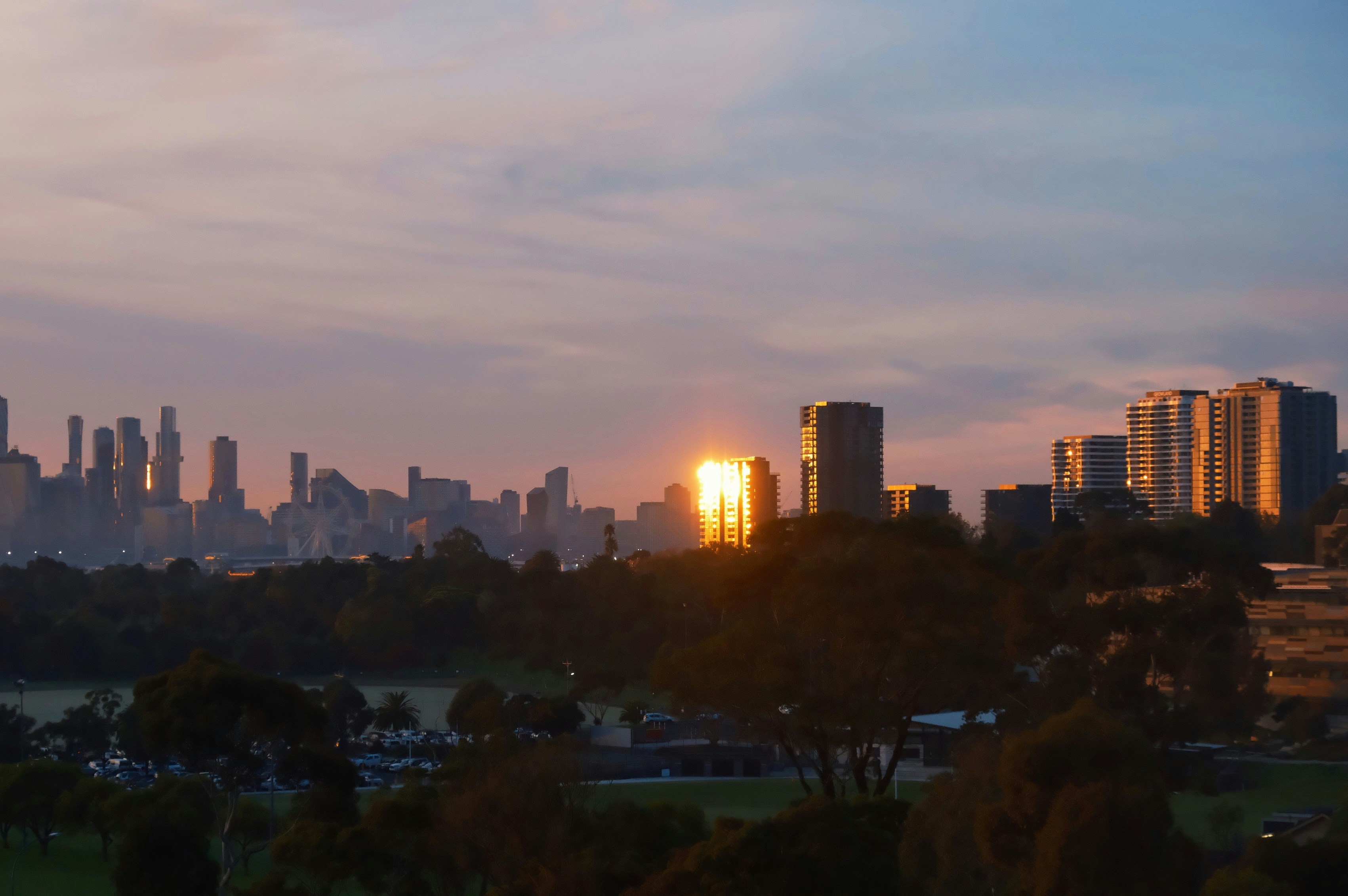 A view of a city skyline at sunset