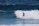 A man riding a wave on top of a surfboard