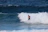 A man riding a wave on top of a surfboard