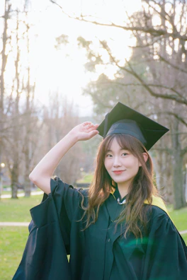 A woman in a graduation gown posing for a picture