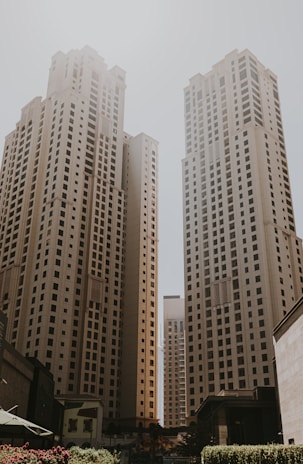 A couple of tall buildings sitting next to each other