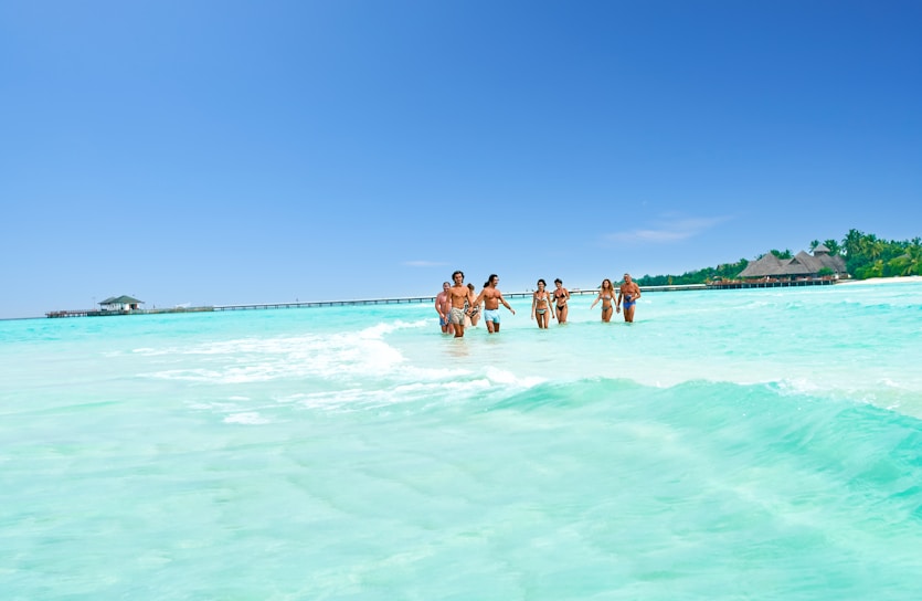 A group of people standing in the ocean