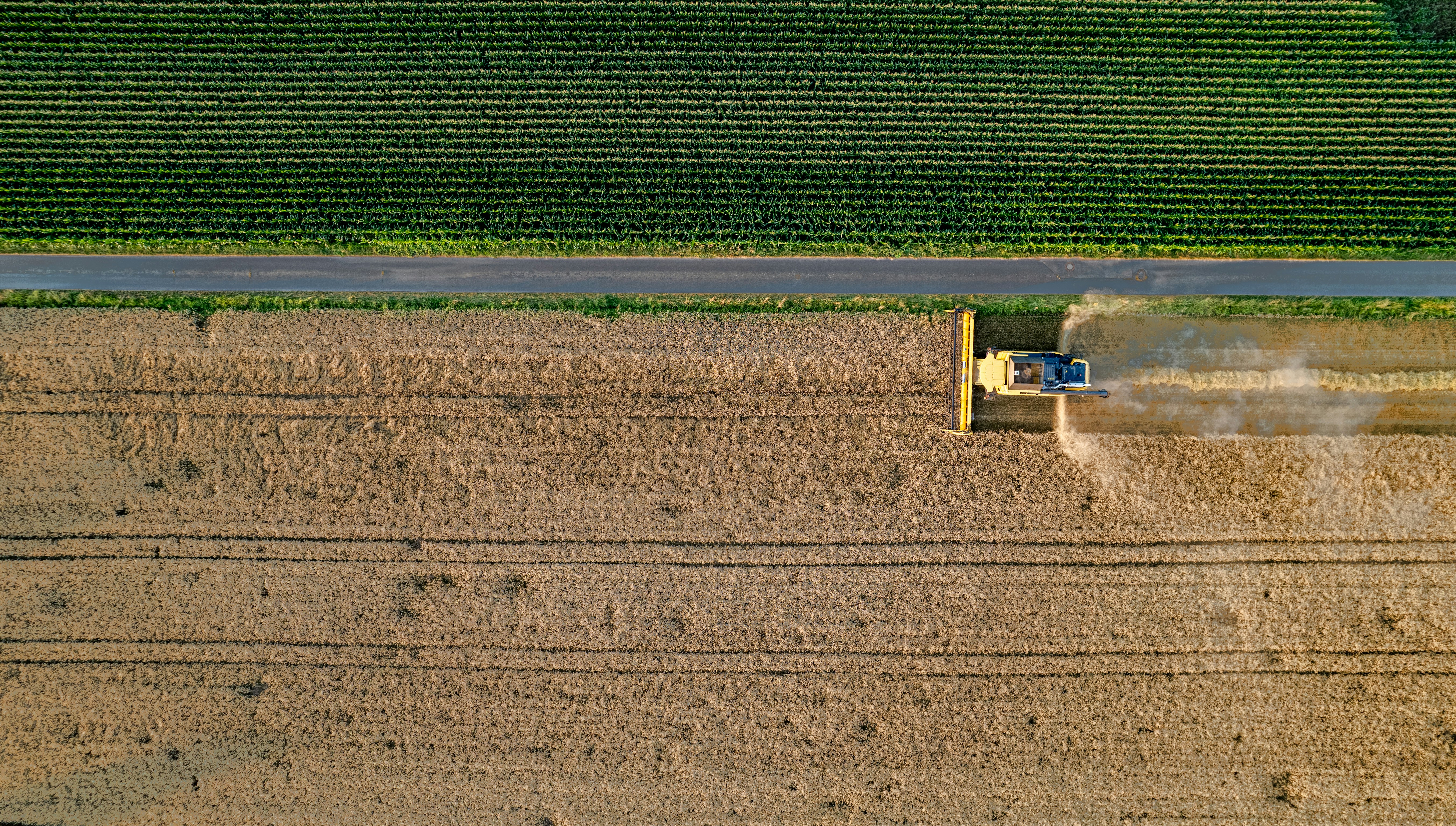 Aerial view of combine harvester working in field