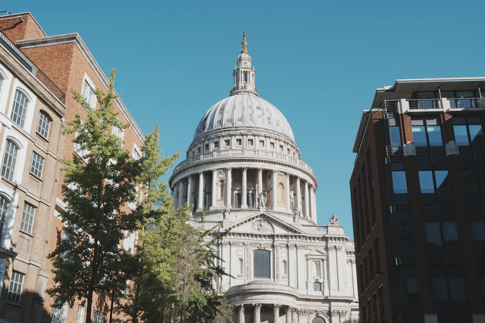 Majestic white building with dome and columns stands tall against clear blue sky